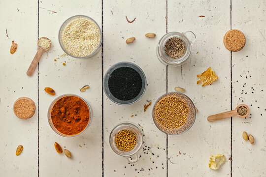 Colourful spices on a wooden table.