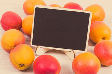 Fresh heap of peach. Healthy dessert as source minerals and vitamins. Place for text on black board