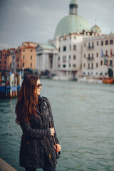 Fototapeta na wymiar female tourist walking around and exploring venice in the early spring