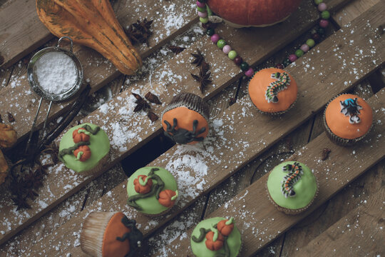 Halloween theme decorated cupcakes with powdered sugar sprinkled on table