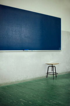 School blue blackboard in a green floor classroom