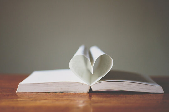 The pages of a book folded into a heart shape.