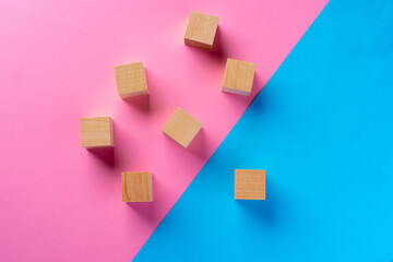 Top view photo of wooden blocks on pink and blue