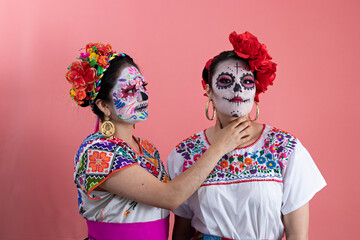 Fototapeta premium Two young women disguised as catrinas
