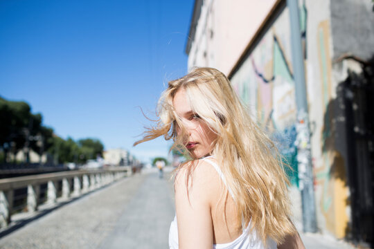 Girl with long blond hair tousled by the wind