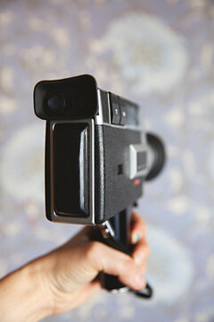 Old super 8 anologue video camera against purple wallpaper