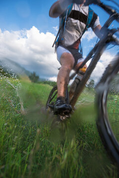 Riding mountan bike through puddle