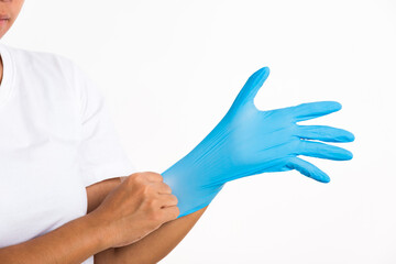 Woman wearing and putting hand to blue rubber latex glove