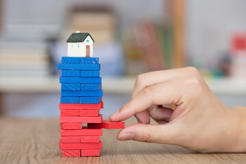 The house model that is gradually in crisis with the building blocks removed