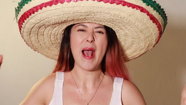 Joven mujer mexicana gritando emocionada por dia de la independencia de mexico viva con sombrero