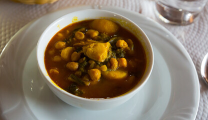 Traditional vegetarian dish from Spain - pottage from chickpea with chard..