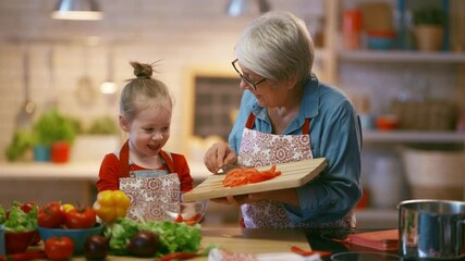 Healthy food at home. Happy family in the kitchen. Grandma and child are preparing the vegetables. - Powered by Adobe