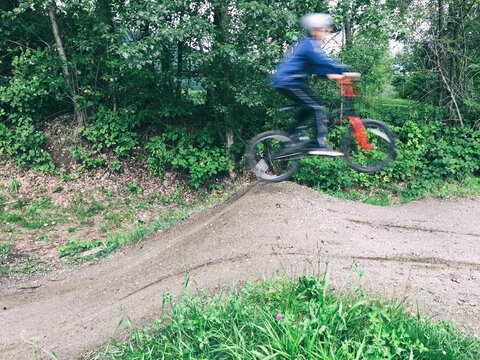 Boy Jumping Bike At BMX Track