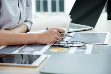 Businesswoman analysis the chart with laptop at the office for setting challenging business goals And planning to achieve the new target