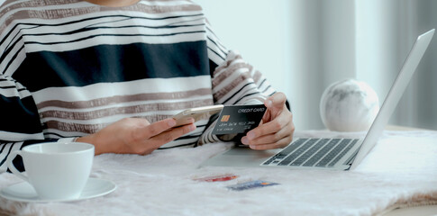 Businesswoman hand holding credit card to online shopping from home, payment e-commerce, internet banking, spending money for next holidays