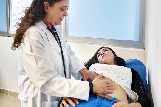 Doctor Checking Patien's Abdomen During Gastro Consult