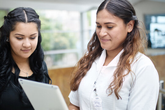 Nurse showing info on a tablet to a patient