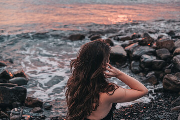 portrait of a Caucasian girl on the background of the sunset sea