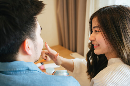  Woman Applying Vaseline On Her Boyfriend Lips.