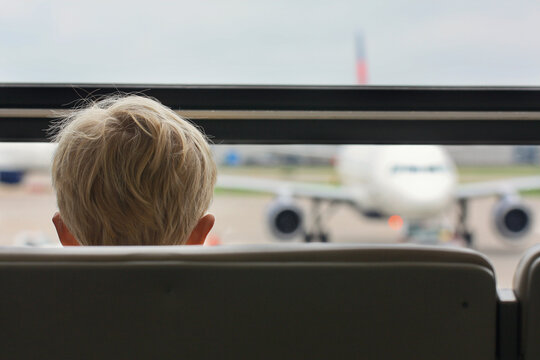 boy watches an airplane