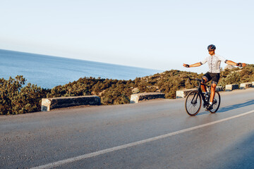 Fototapeta premium Cycling sport athlete man riding on coastal road