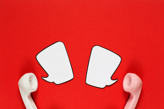 Two phone handsets talking about love with comic bubbles