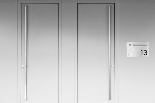 Monochromatic image of doors on a modern house