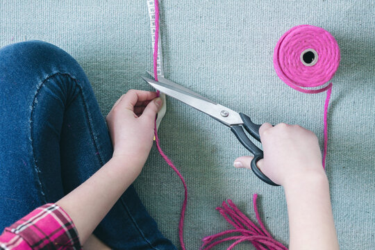 Macrame project, step one, measure and cut lengths of string