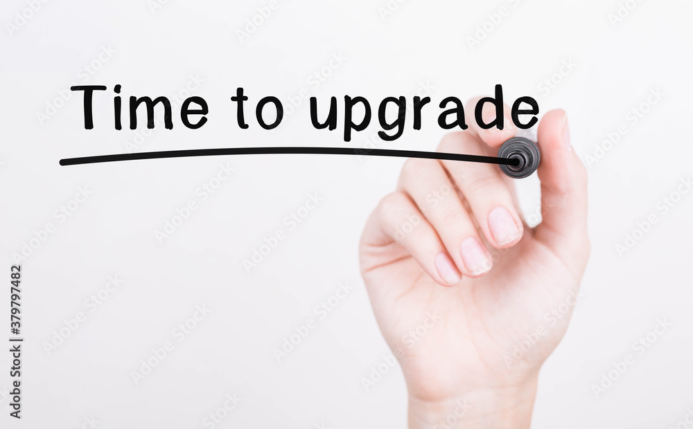 Poster hand writing time to upgrade with black marker on transparent wipe board