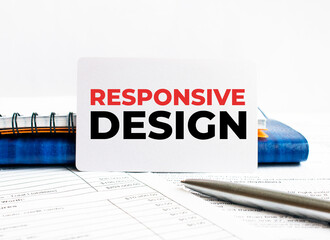 Business card with text RESPONSIVE DESIGN lying on blue notebook