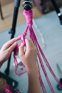 Macrame project, step 4: hang your ring and begin to make knots with each pair of string