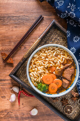 A bowl of braised beef noodles in a tray