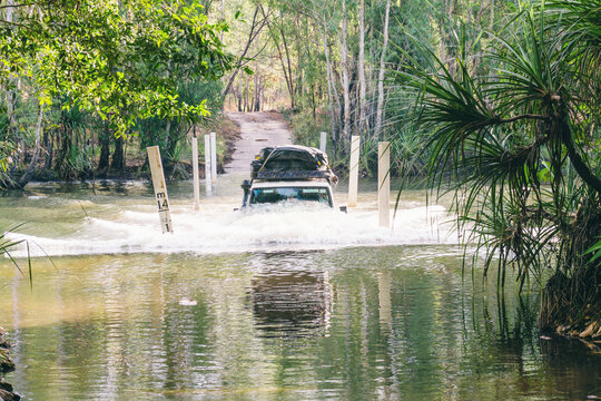 half submerged suv as it crosses a river