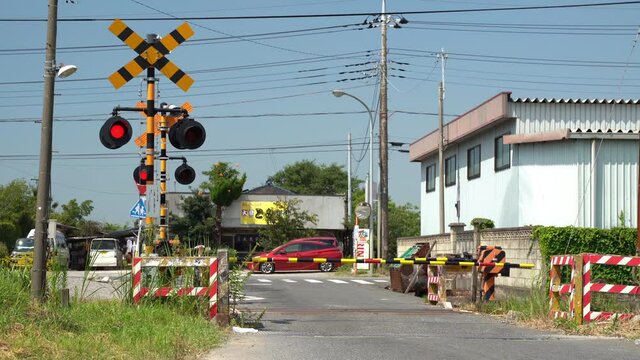 Passing a railroad crossing on a local line. Japanese landscape