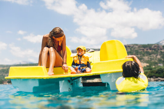 Mother and her kid on a pedal boat