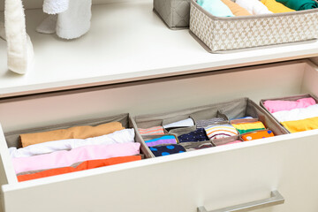 Open drawer with clean clothes in closet