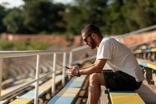 Young man standing on an empty stadium