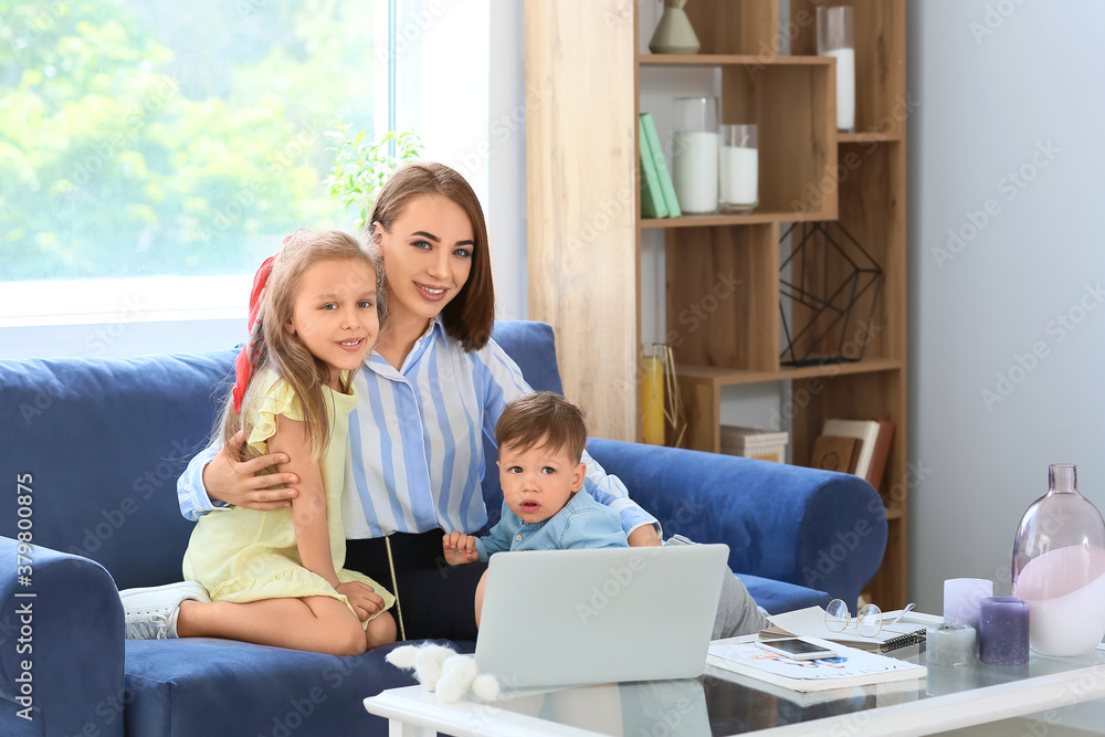 Wall mural working mother with little children at home