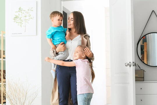 Happy Children Meeting Their Mother After Work At Home