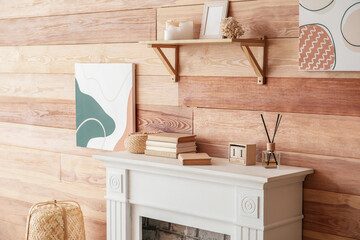 Modern fireplace near wall in room