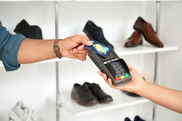 Man paying bill in modern shoe store