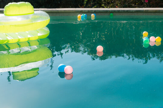lilo and pool balls floating on the pool