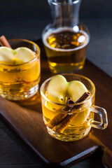 Hot apple cider cocktail with cinnamon and apple slices