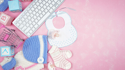 Baby nursery clothing mom bloggers desktop workspace with pink and blue accessories on stylish pink textured background. Top view blog hero header creative composition flat lay. Negative copy space.