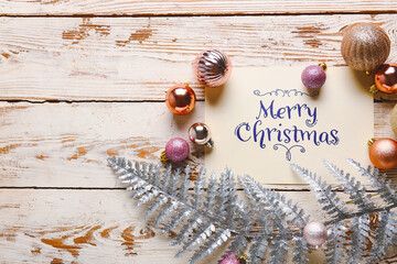 Beautiful composition with Christmas greeting card on wooden background