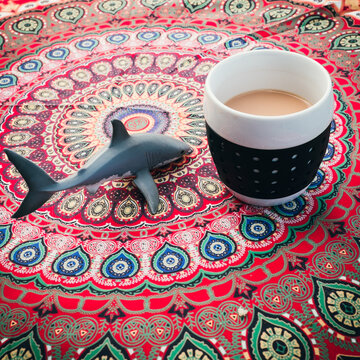 A cup of tea on a bohemian table cloth