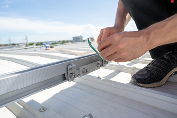 installing grounding in steel bar of solar rooftop power system by barehanded stock photo