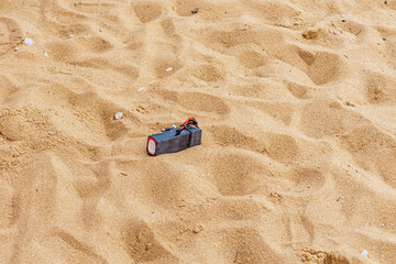 an unusual object with black wires similar to a bomb lies on the sand in a public place none of the...