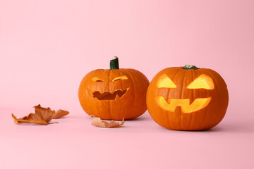 Carved Halloween pumpkins on color background