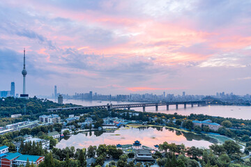 Fototapeta na wymiar Early morning colorful clouds at Guishan TV Tower and Yangtze River Bridge in Wuhan, Hubei, China